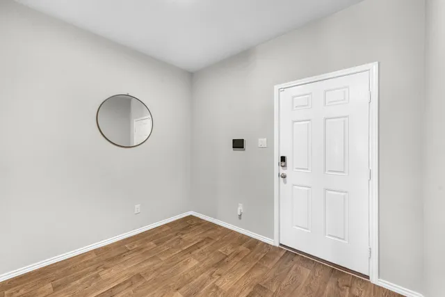 a view of a room with wooden floor and white wall