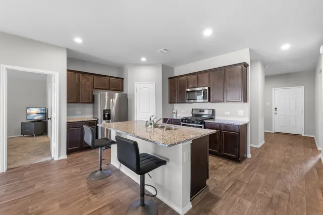 a kitchen with a sink cabinets and stainless steel appliances