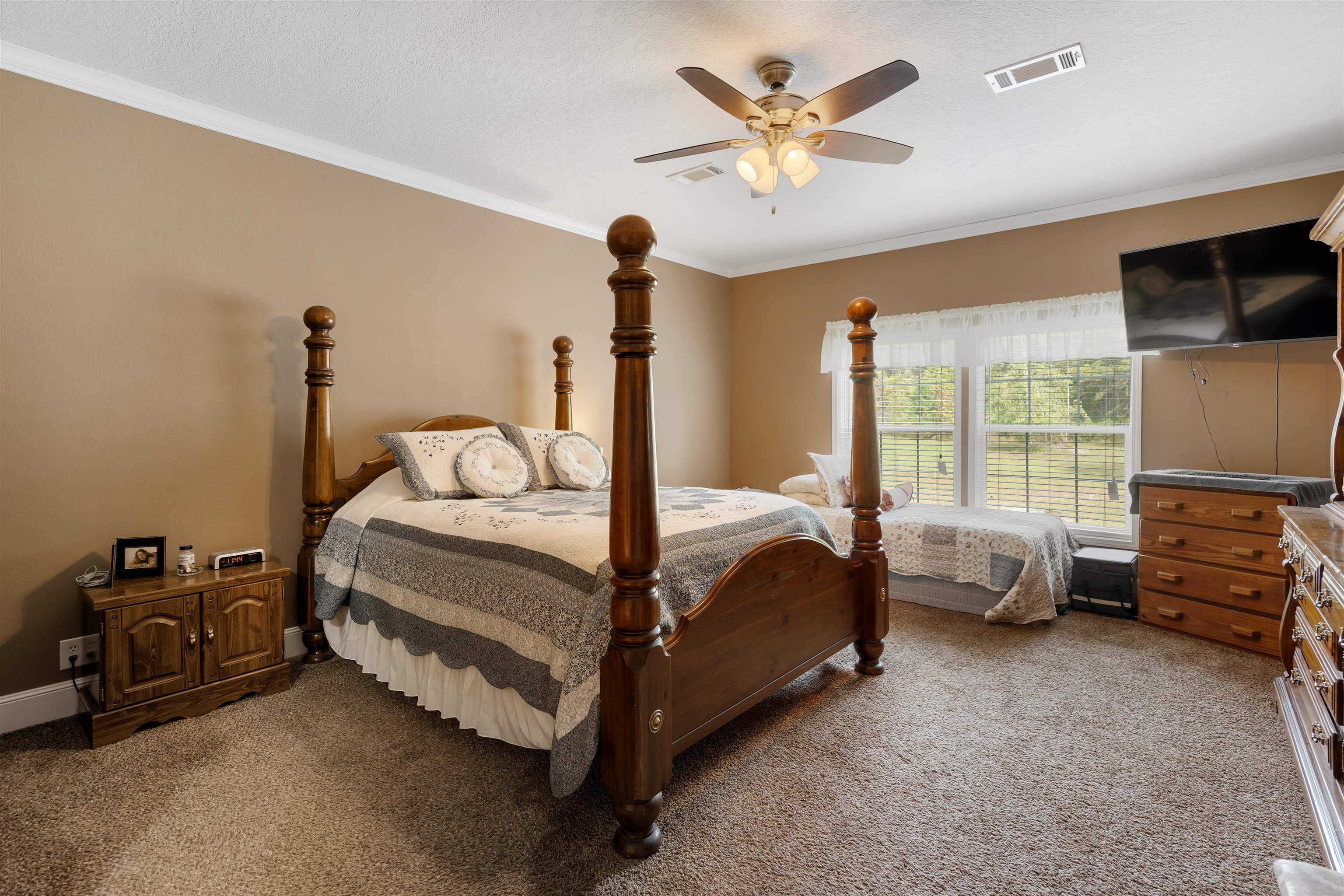 3000 Lightsey Road St. Augustine, FL 32084 - Photo 11 of 35 a bedroom with a bed a couch and a flat tv screen