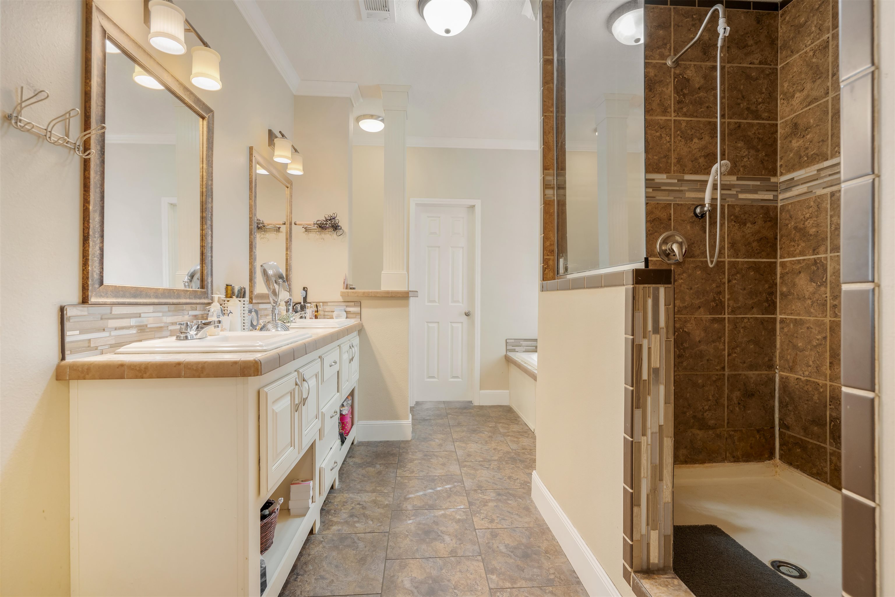 3000 Lightsey Road St. Augustine, FL 32084 - Photo 13 of 35 a bathroom with a double vanity sink a mirror and a shower
