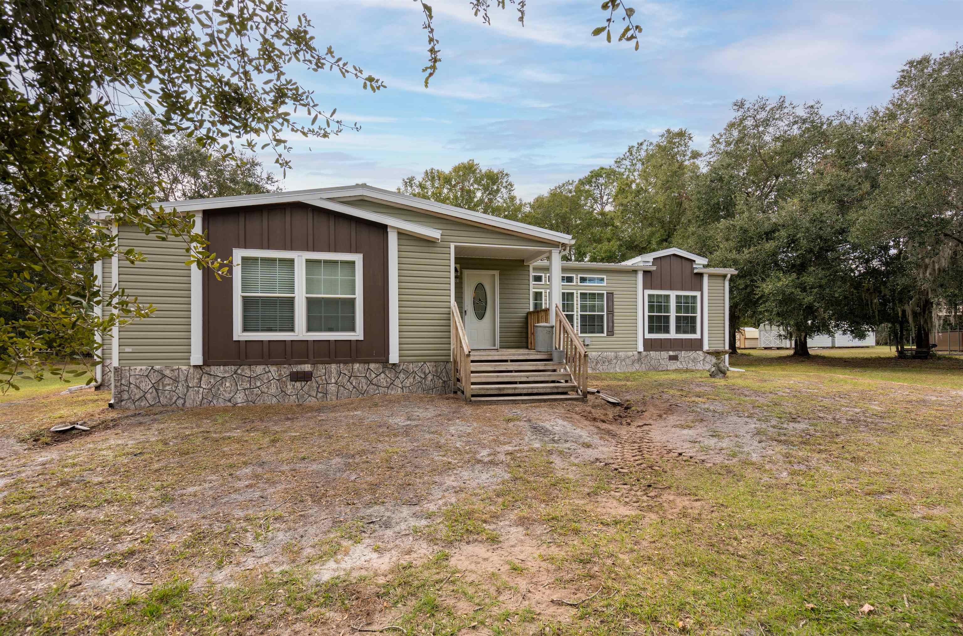 3000 Lightsey Road St. Augustine, FL 32084 - Photo 23 of 35 a white house that has a tree in front of it