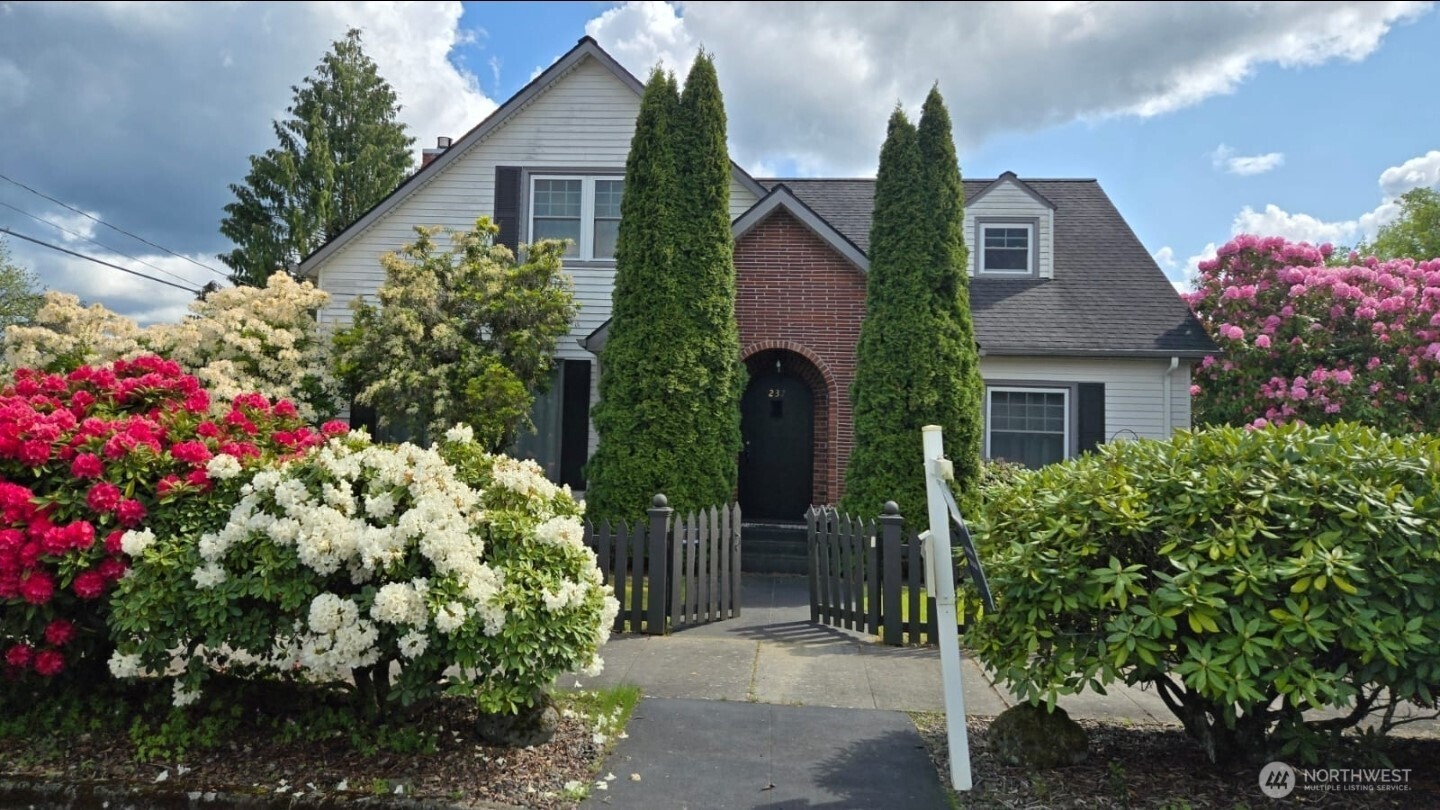 237 C Street Southwest Castle Rock, WA 98611 - Photo 2 of 33 a front view of a house with a yard and garage