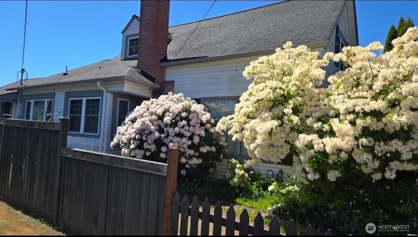237 C Street Southwest Castle Rock, WA 98611 - Photo 5 of 33 a view of a house with a flower garden