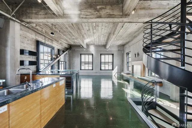 a view of a living room with hardwood floor and a large window