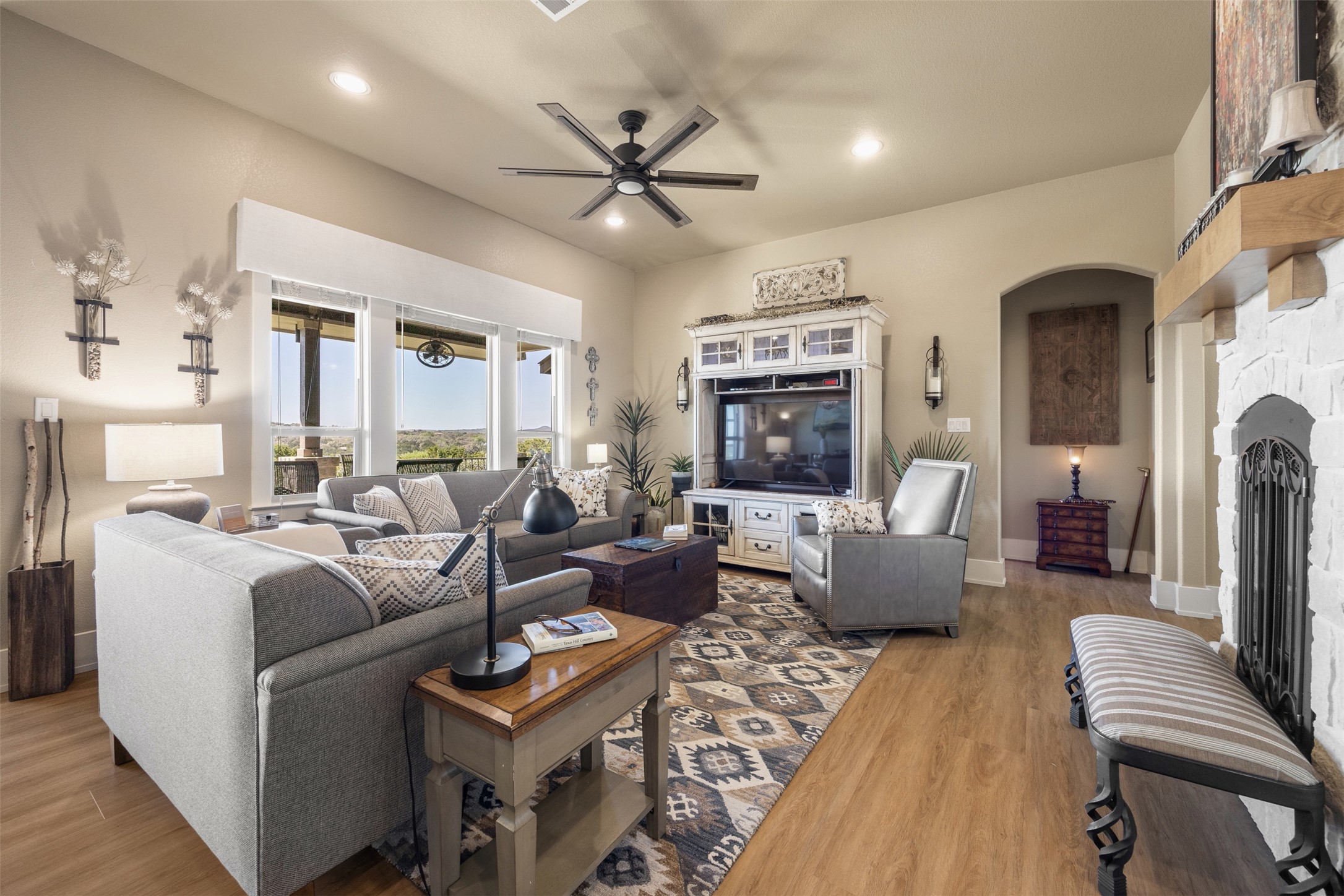 261 Barber Drive Wimberley, TX 78676 - Photo 8 of 37 Living area featuring a fireplace, a ceiling fan, light wood-style flooring, and recessed lighting