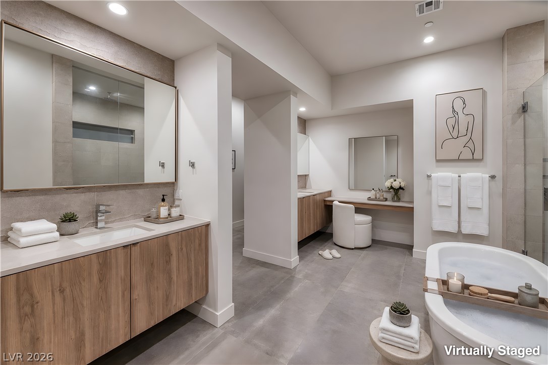 25 Falling Ridge Lane Henderson, NV 89011 - Photo 17 of 48 Indulge in this well-appointed bath, featuring a soaking tub and dual vanities.