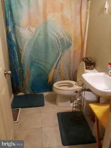 a bathroom with a toilet and a sink