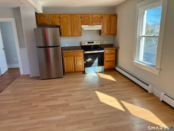 a kitchen with a refrigerator sink and cabinets