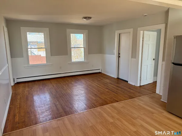 wooden floor in an empty room with a window