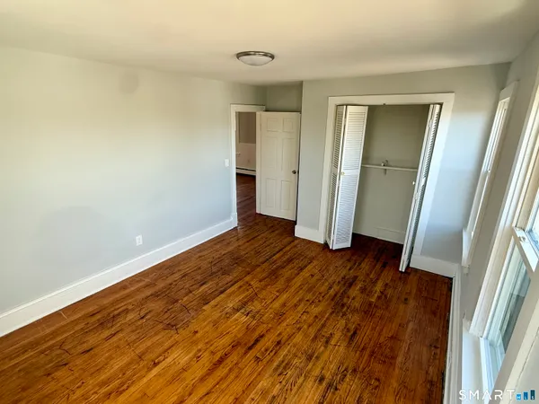 a view of a room with wooden floor and staircase
