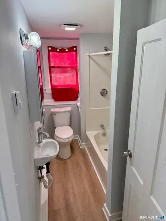 a bathroom with a toilet a sink and bathtub