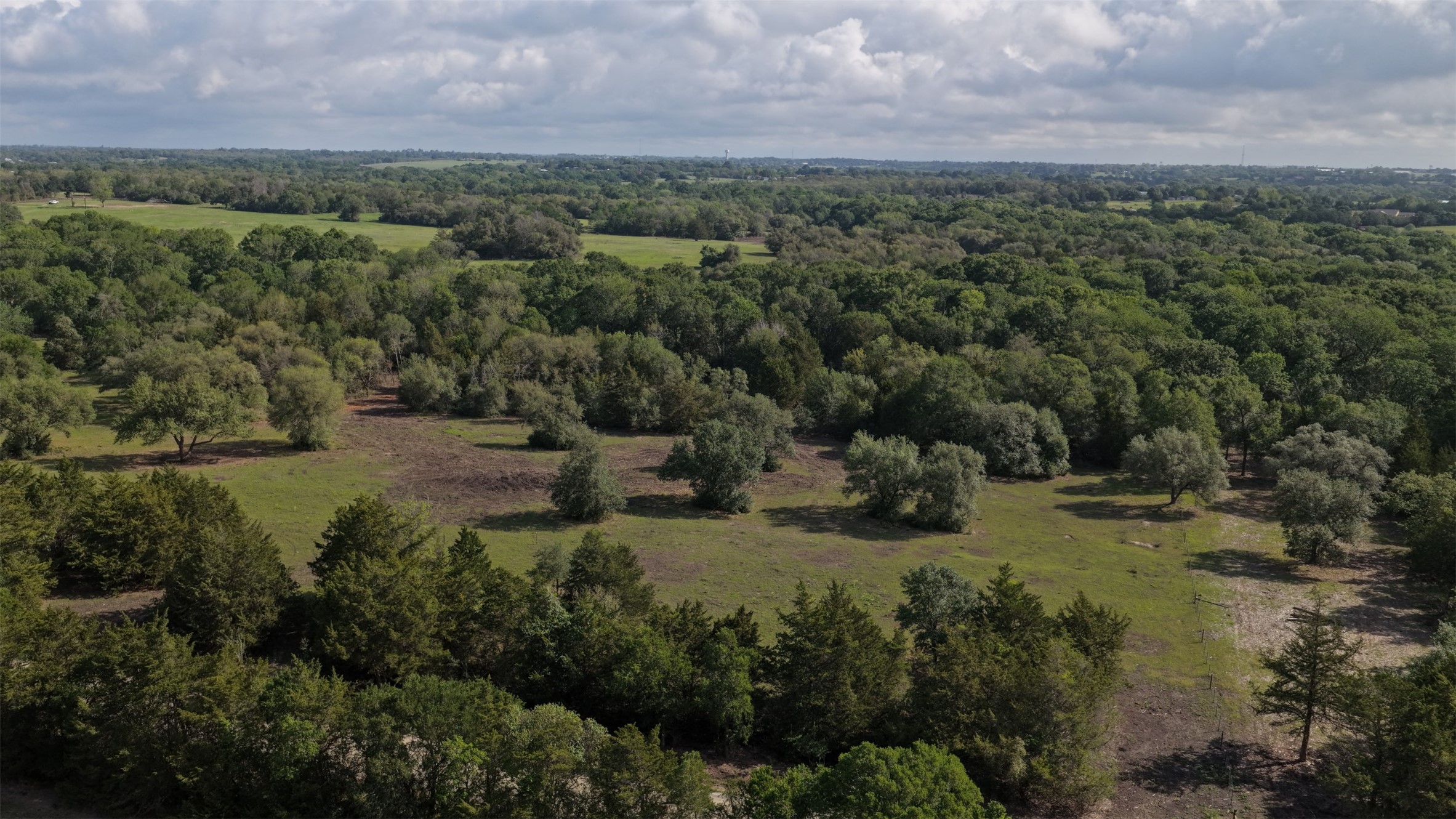 8 Baranowski Road Brenham, TX 77833 - Photo 2 of 6 a view of a city with lush green forest