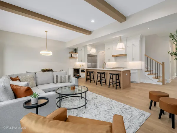 a living room with furniture and kitchen view