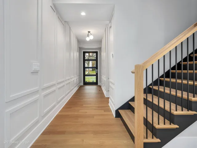 a view of an entryway with wooden floor
