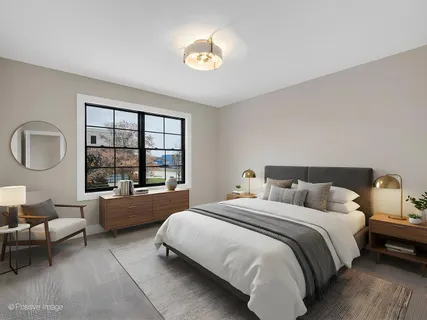 a spacious bedroom with a bed couch and window