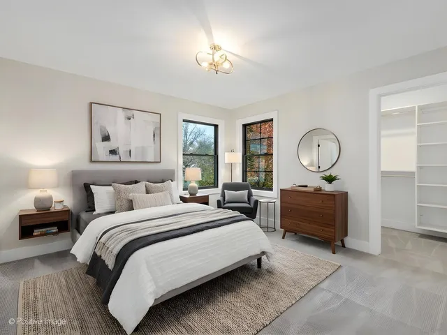 a bedroom with bed and a chandelier