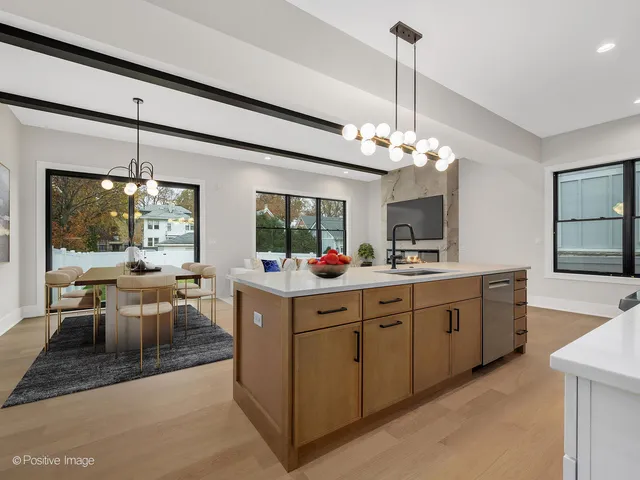 a kitchen with sink and view of living room