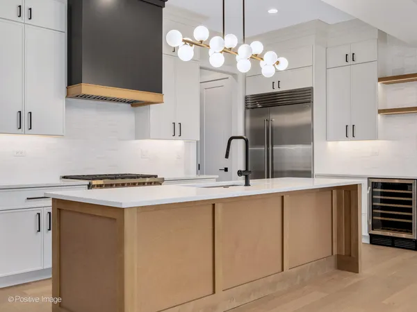 a kitchen with cabinets a sink and appliances
