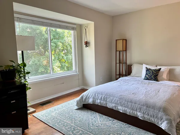 a bedroom with a bed and a window