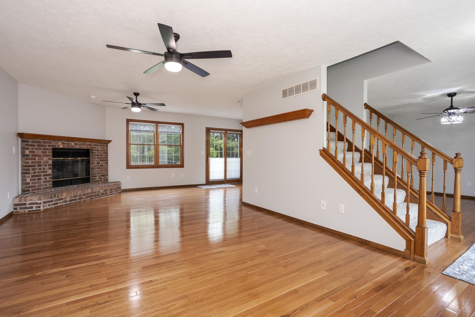 814 Landau Lane Normal, IL 61761 - Photo 13 of 58 a view of an empty room with wooden floor and a window
