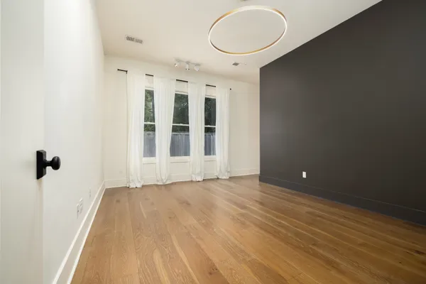 a view of a room with wooden floor and entryway