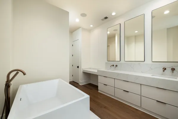 a bathroom with a double vanity sink and mirror