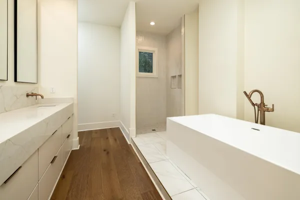 a spacious bathroom with a bathtub and sink