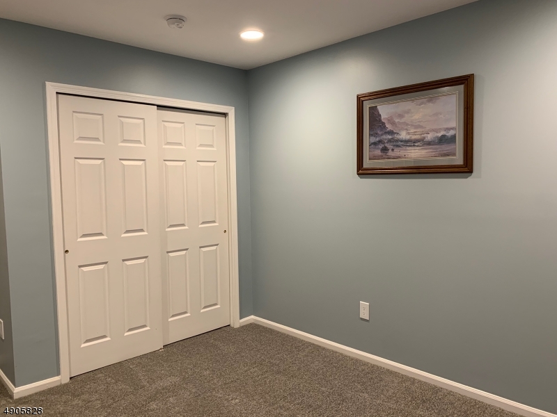 105 Well Sweep Road, Unit 105 Whitehouse Station, NJ 08889 - Photo 13 of 22 an empty room with windows and closet