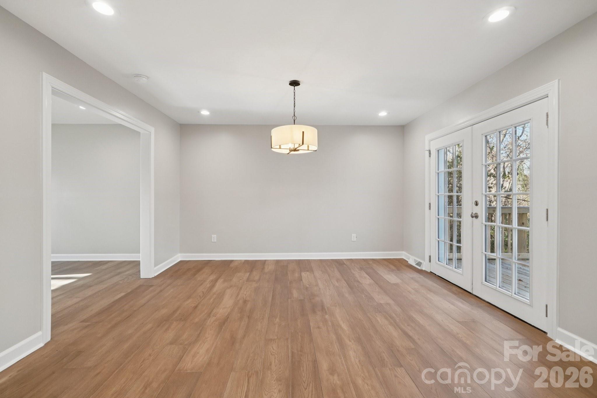 1216 Old Farm Road Charlotte, NC 28226 - Photo 12 of 36 wooden floor in an empty room with a window