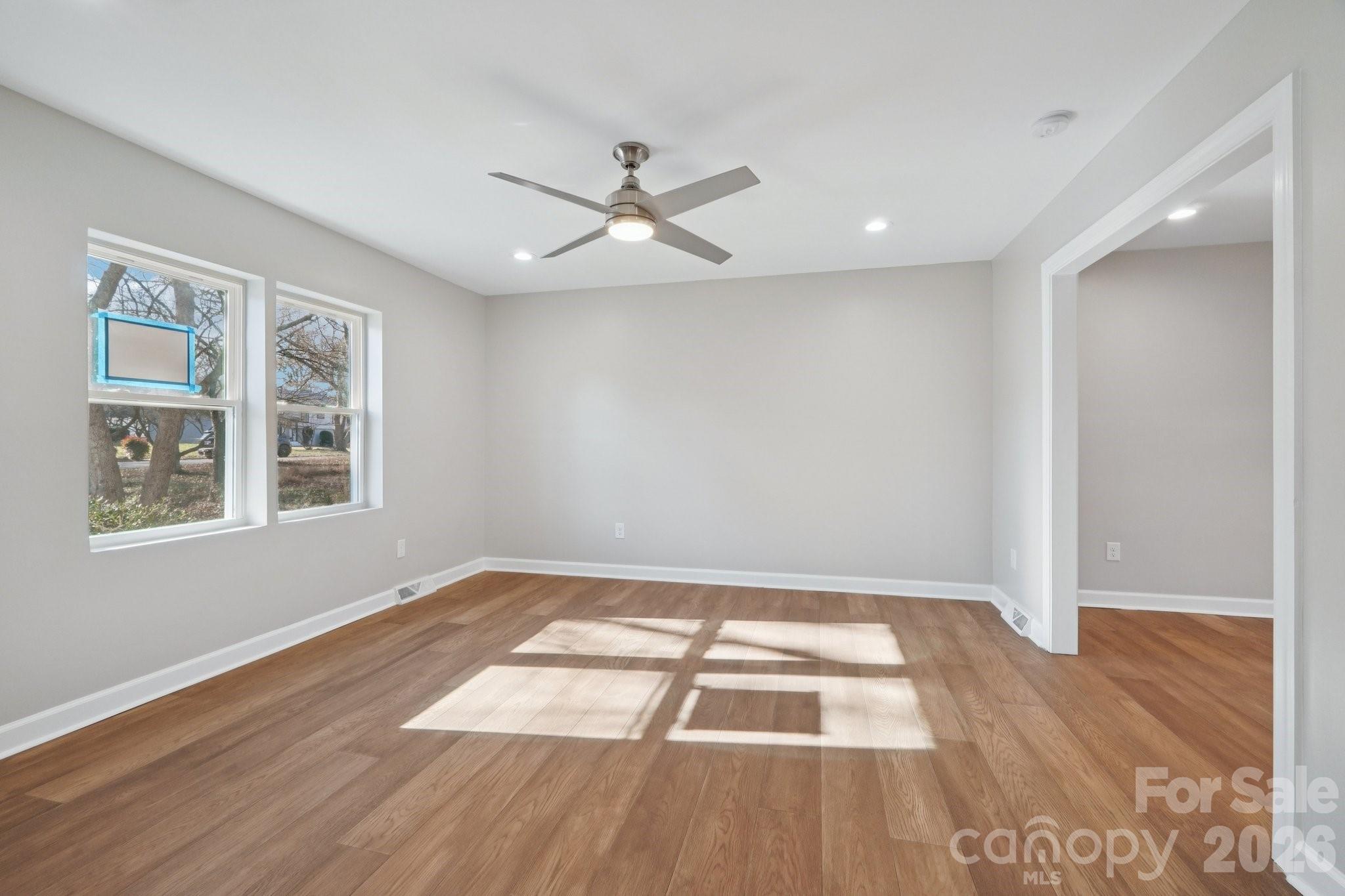 1216 Old Farm Road Charlotte, NC 28226 - Photo 14 of 36 a view of empty room with wooden floor and fan