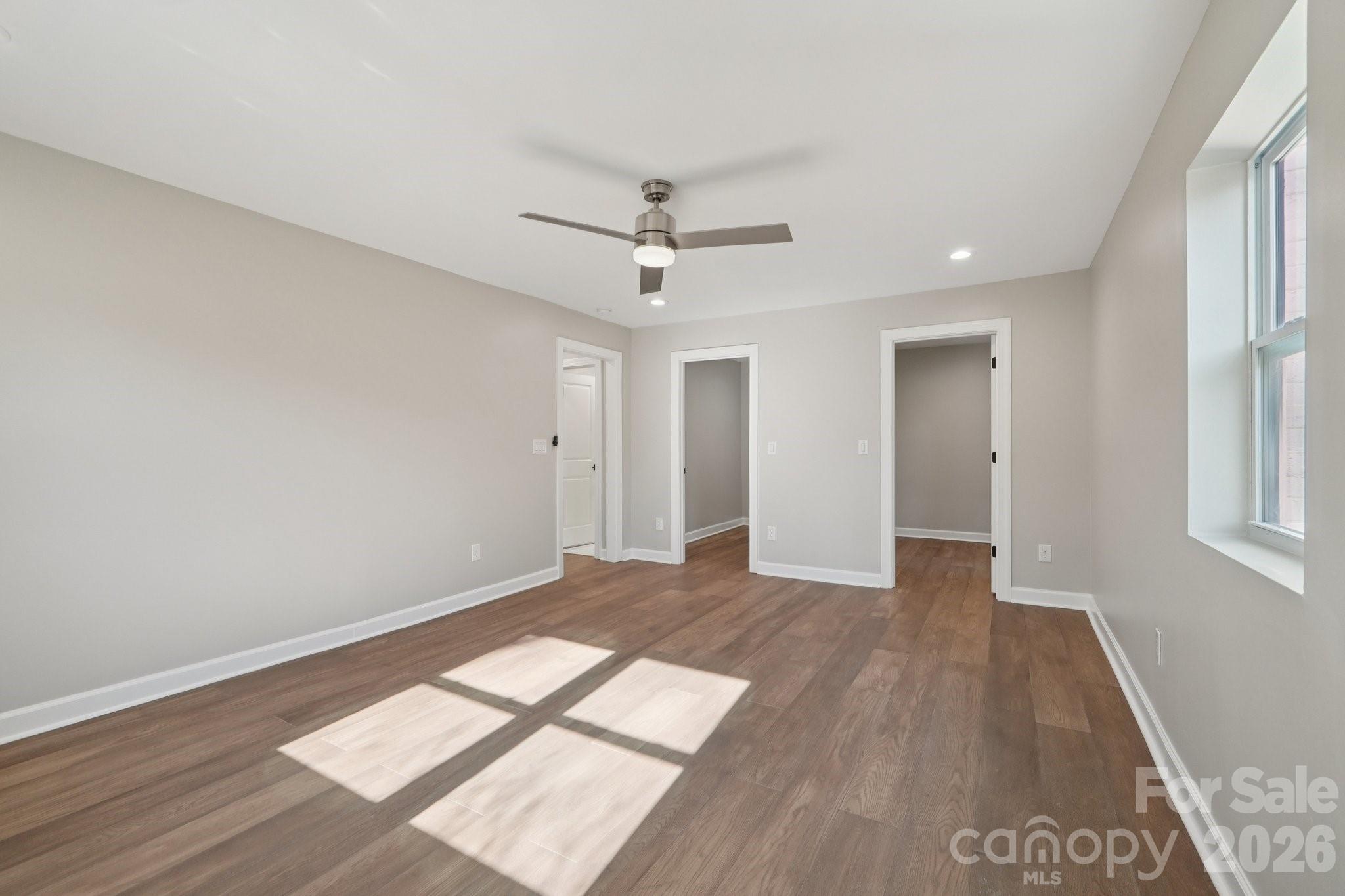 1216 Old Farm Road Charlotte, NC 28226 - Photo 18 of 36 an empty room with wooden floor and windows