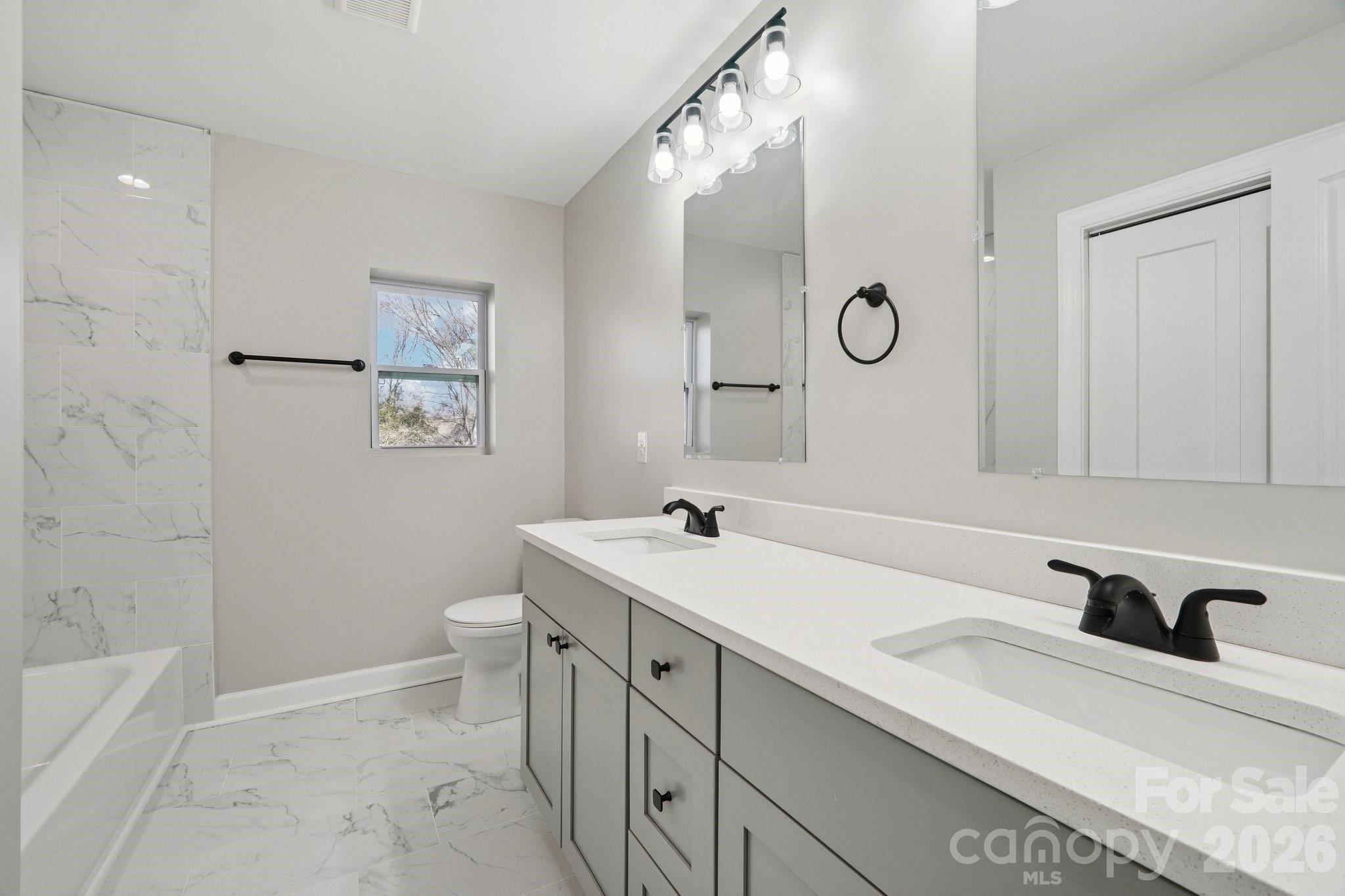 1216 Old Farm Road Charlotte, NC 28226 - Photo 19 of 36 a bathroom with a sink a toilet and a mirror