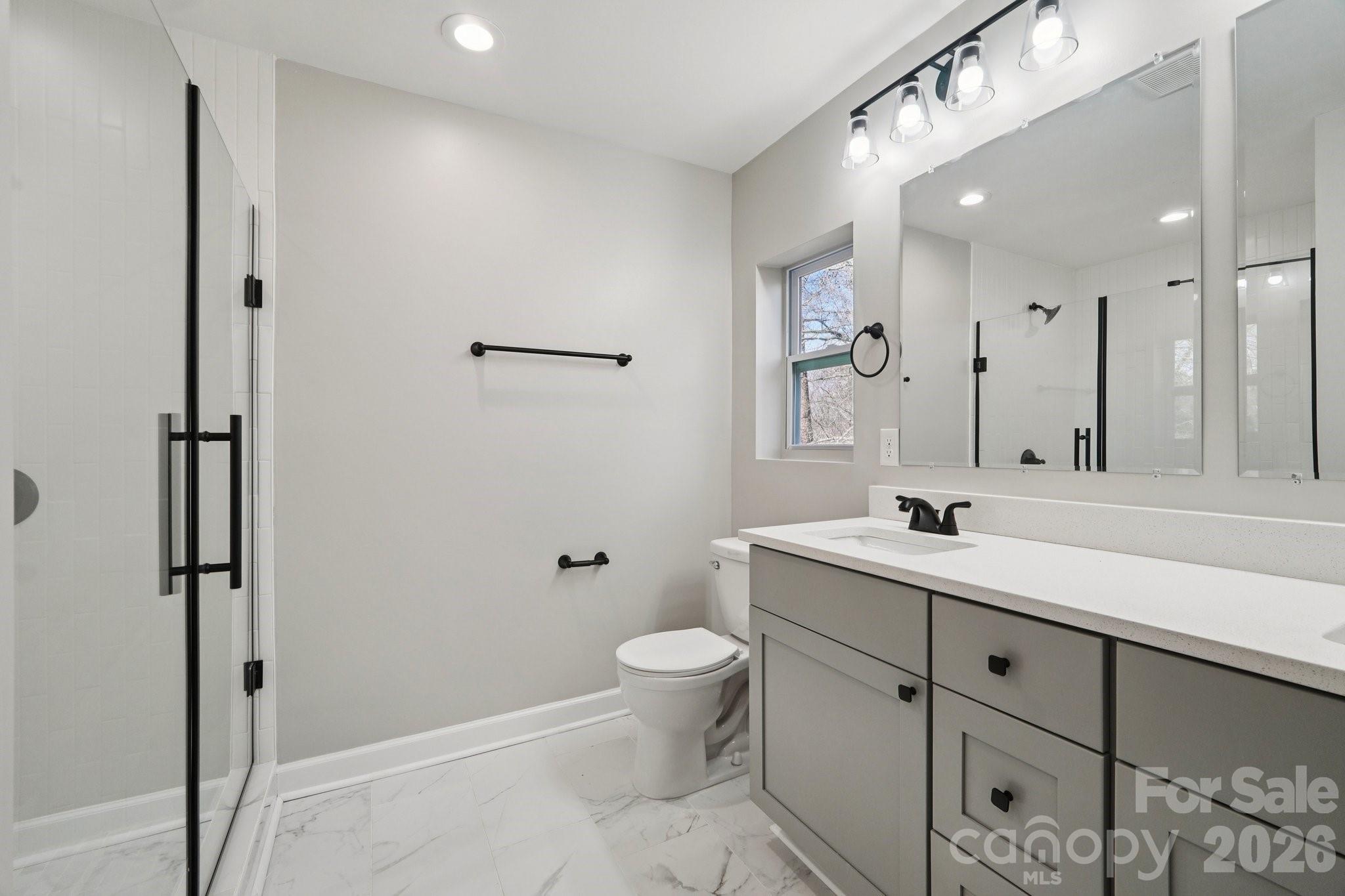 1216 Old Farm Road Charlotte, NC 28226 - Photo 21 of 36 a bathroom with a sink a toilet and a mirror
