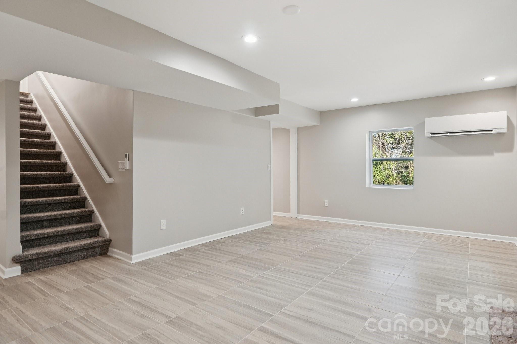 1216 Old Farm Road Charlotte, NC 28226 - Photo 23 of 36 a view of an empty room with wooden floor and stairs