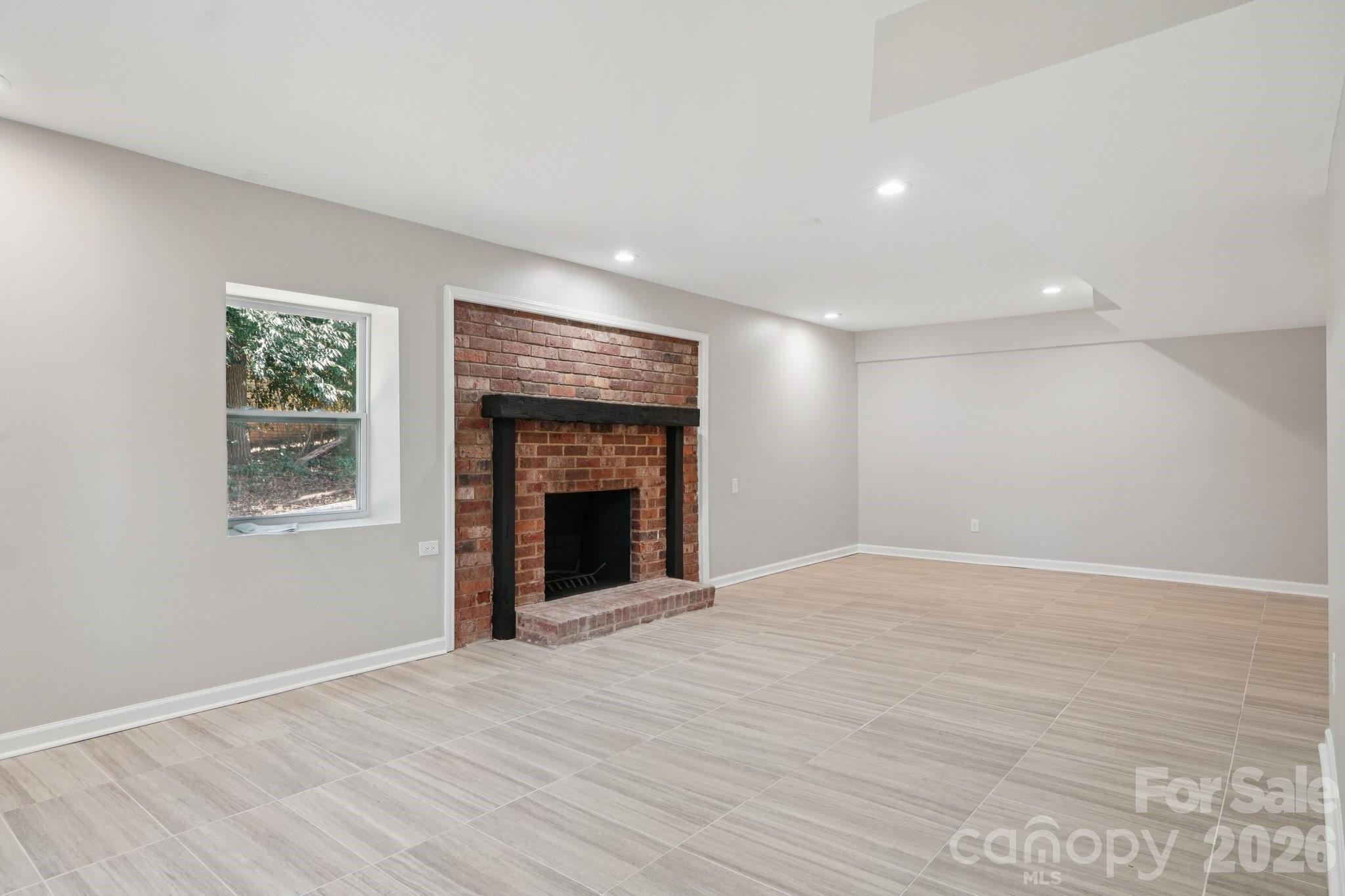 1216 Old Farm Road Charlotte, NC 28226 - Photo 25 of 36 a view of an empty room with a fireplace and a window