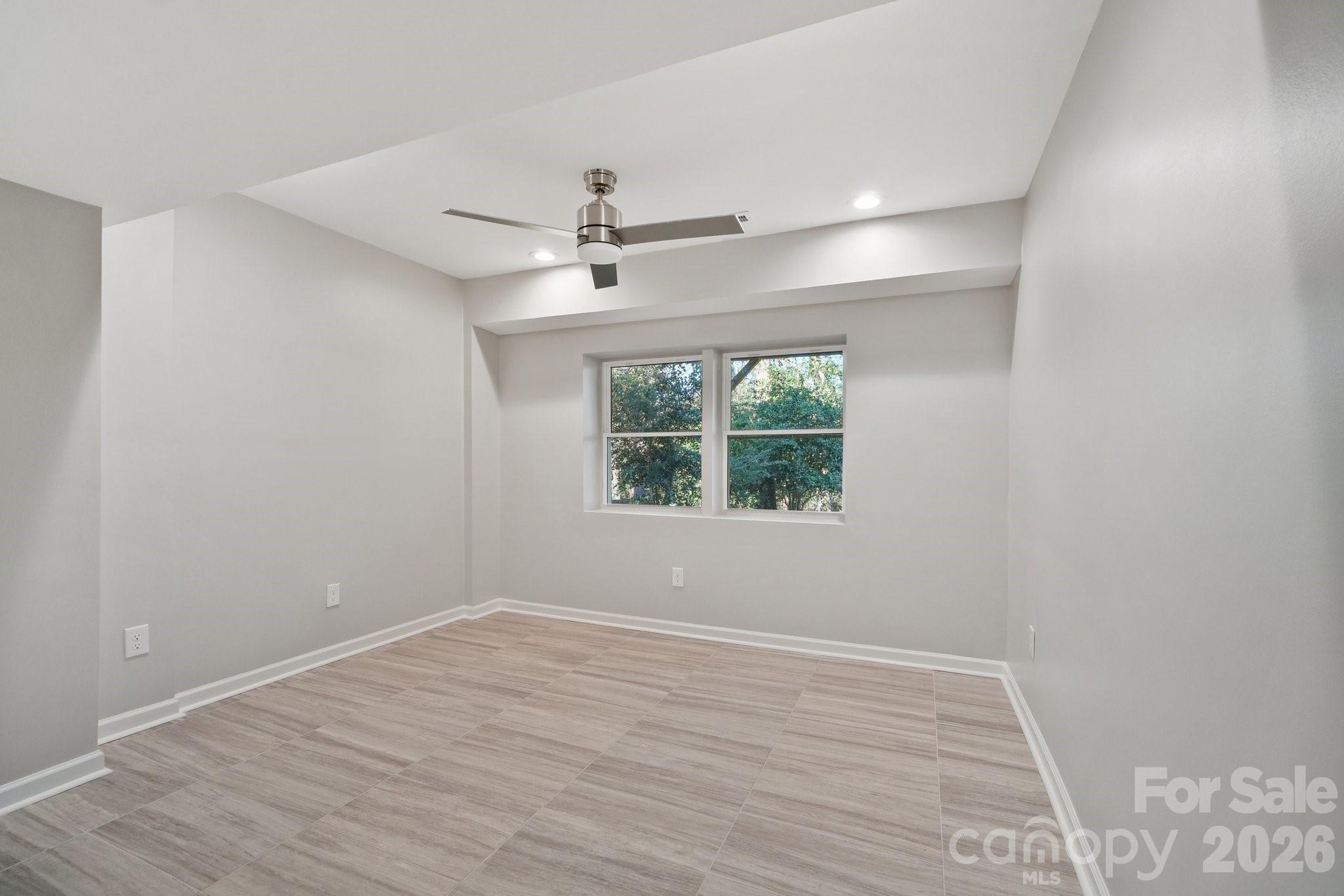1216 Old Farm Road Charlotte, NC 28226 - Photo 28 of 36 a view of an empty room with wooden floor and a window