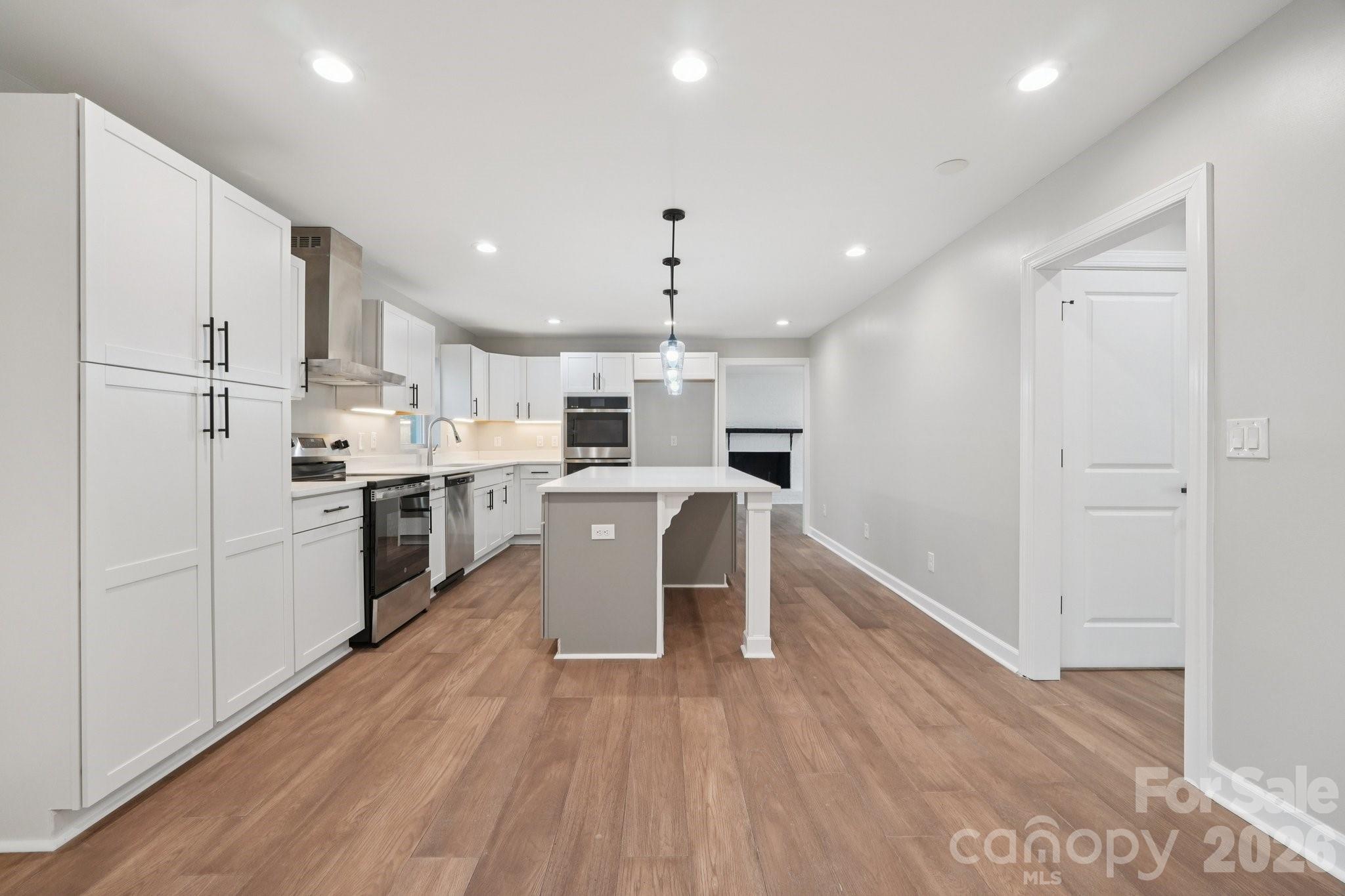 1216 Old Farm Road Charlotte, NC 28226 - Photo 10 of 36 a kitchen with white cabinets and white appliances