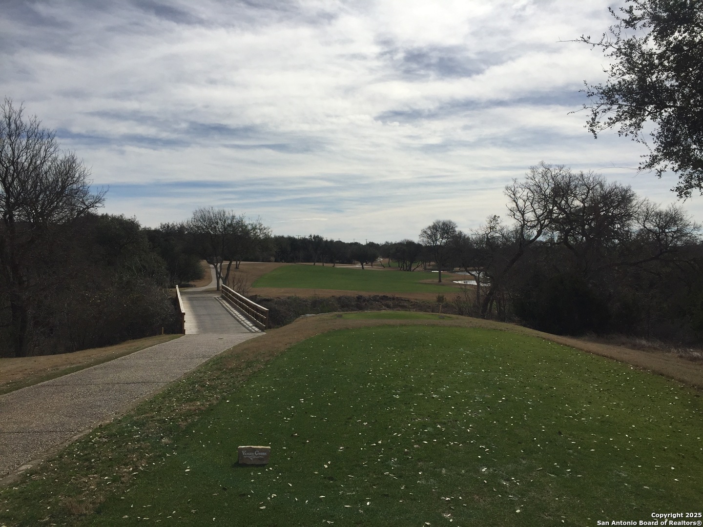 112 Riley Wood Blanco, TX 78606 - Photo 5 of 9 a view of a river and garden with trees in the background