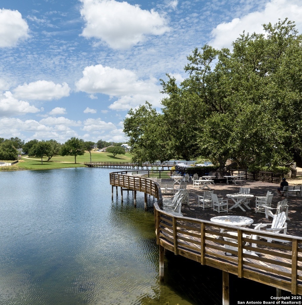 112 Riley Wood Blanco, TX 78606 - Photo 7 of 9 a view of a lake with a house in the background