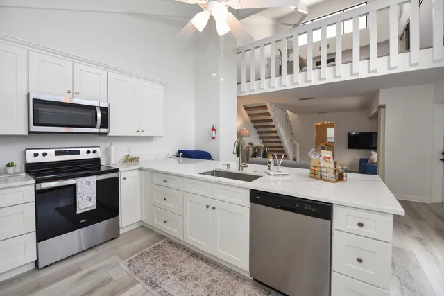 a kitchen with a sink stove and microwave