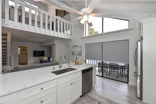 a bathroom with double vanity and a bathtub