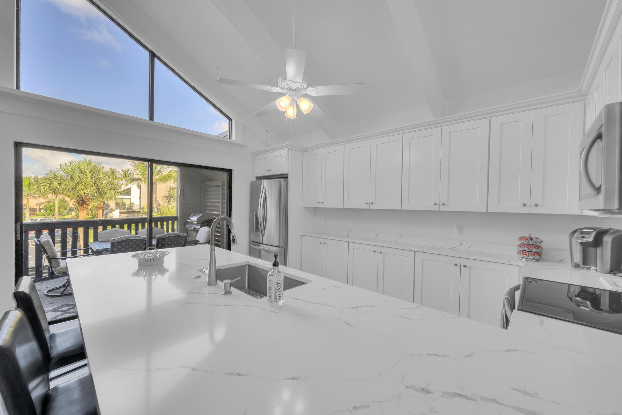 1605 Highway 1, Unit SL3G Jupiter, FL 33477 - Photo 15 of 54 a large white kitchen with a large window