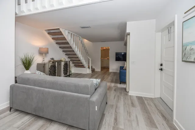 a living room with furniture and a wooden floor
