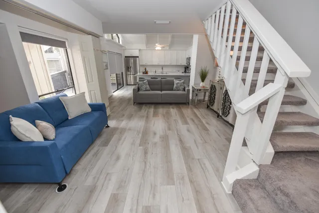 a living room with furniture and a wooden floor