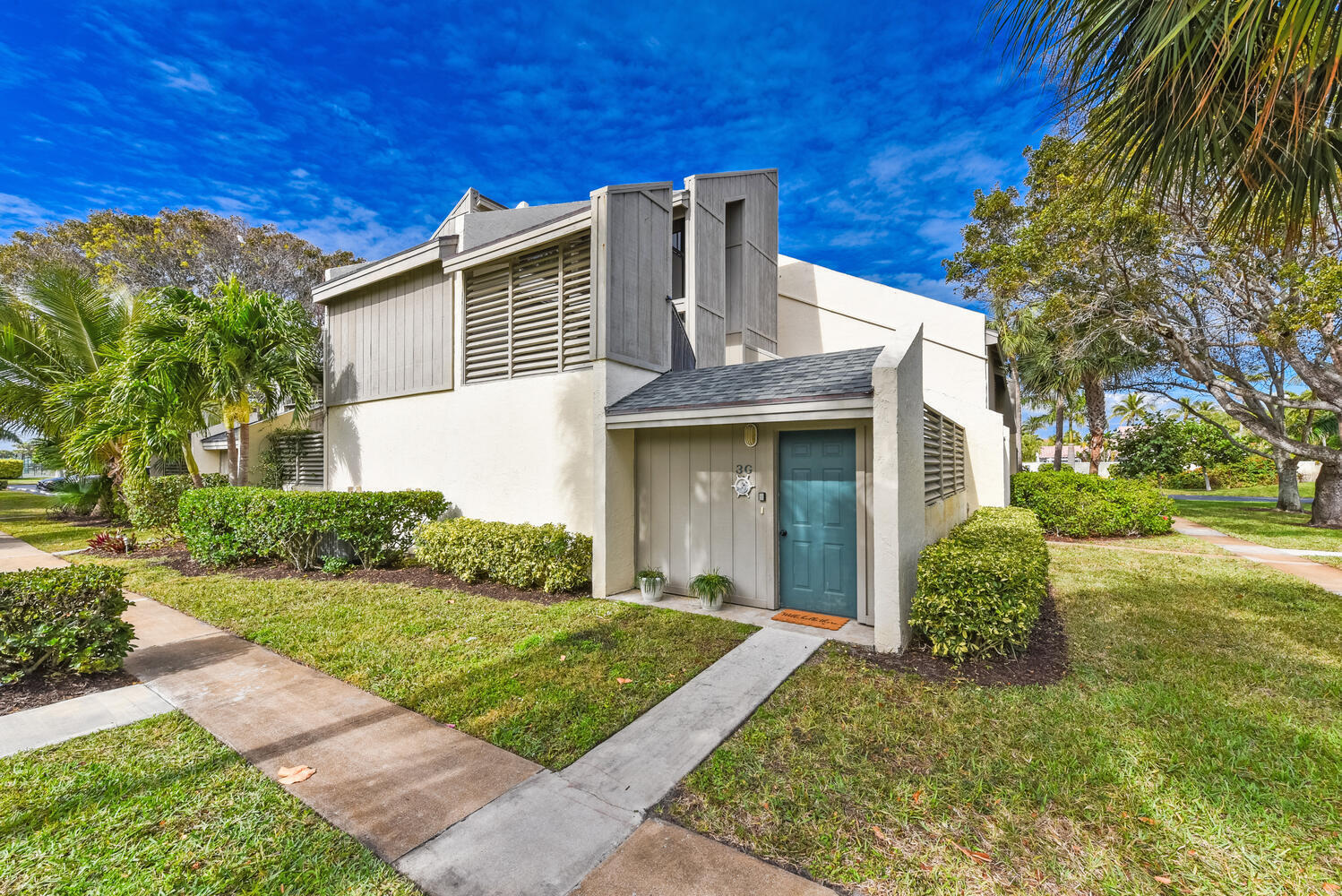 1605 Highway 1, Unit SL3G Jupiter, FL 33477 - Photo 2 of 54 a view of a house with brick walls and a yard with plants