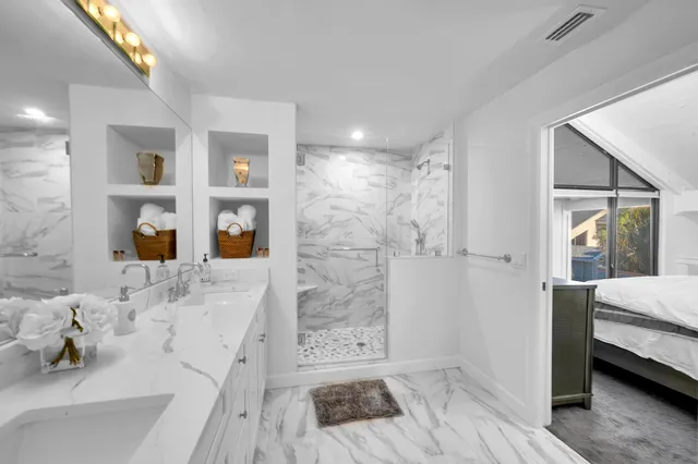 a bathroom with a tub shower sink and mirror