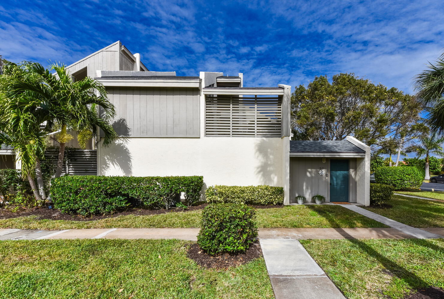 1605 Highway 1, Unit SL3G Jupiter, FL 33477 - Photo 3 of 54 a front view of a house with a yard