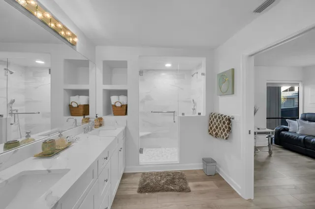 a spacious bathroom with a granite countertop sink mirror and vanity