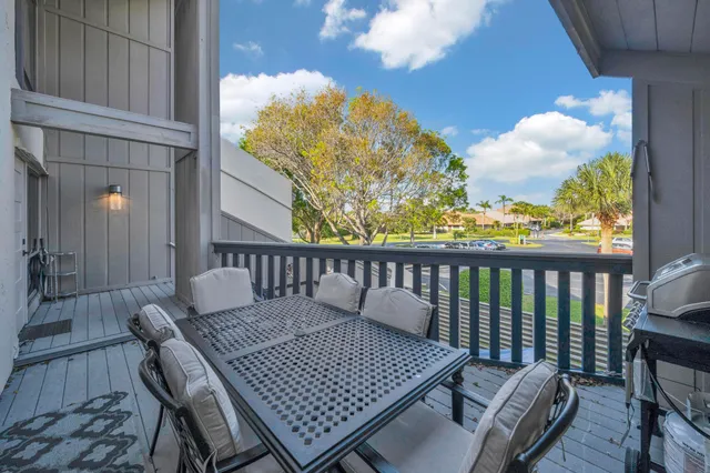 a view of a balcony with wooden floor