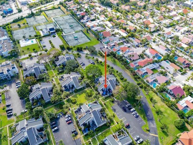 an aerial view of a house with a yard and trees